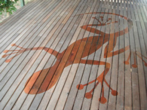 Lizard art carved into the wooden deck